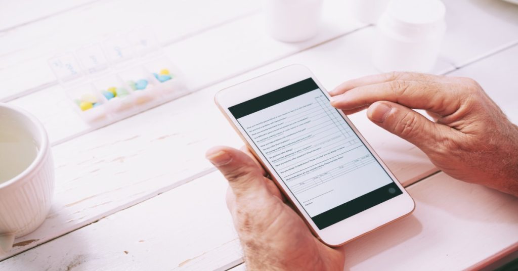 Man using a smartphone to fill a short survey form, representing higher survey participation.